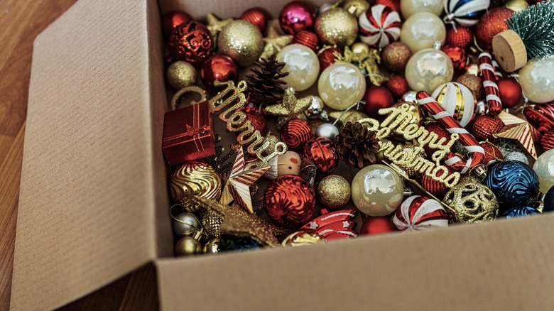 A cardboard box filled with old Christmas decor items