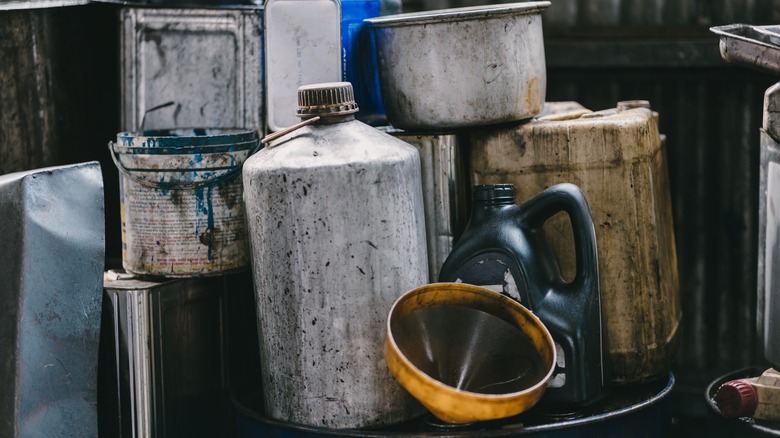 Old dirty lubricant bottles in garage