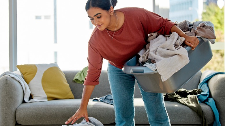 person picking up laundry