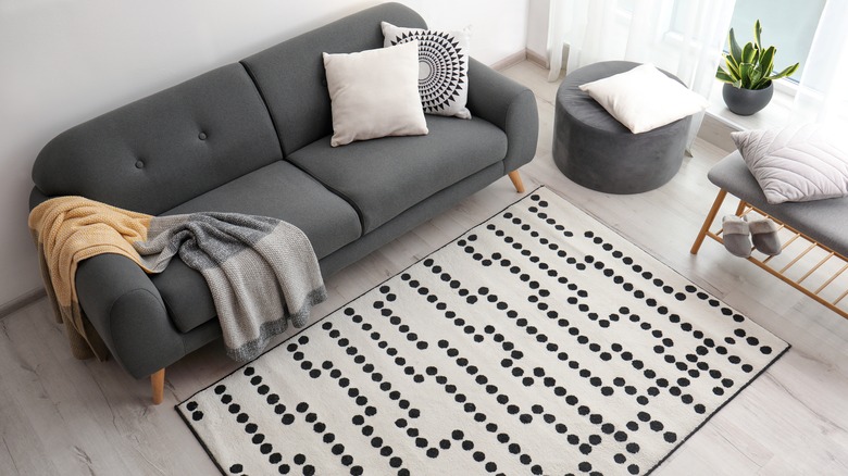 blanket draped across gray couch