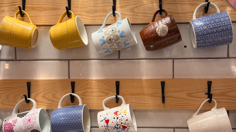 Coffee mugs on wall hooks