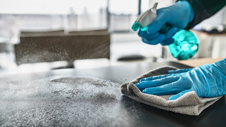 cleaning kitchen countertops with Windex