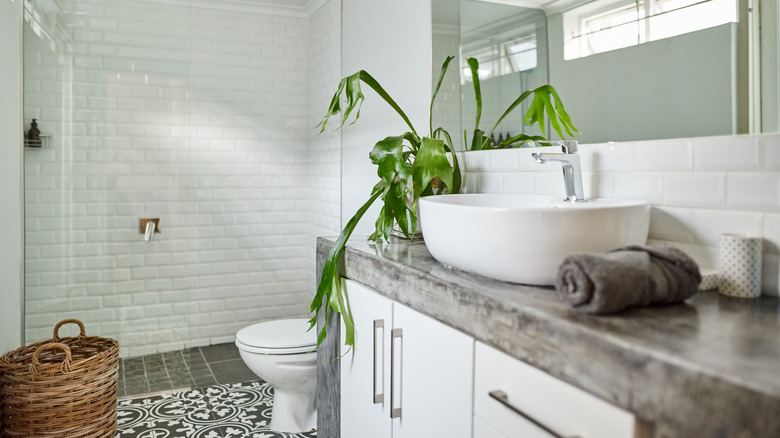 Modern bathroom with the toilet tucked behind the vanity