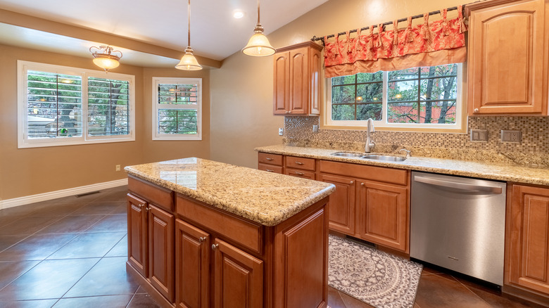 A dated kitchen with wood cabinets