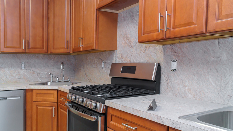 Modern-looking kitchen with richer wood tone cabinets and new hardware