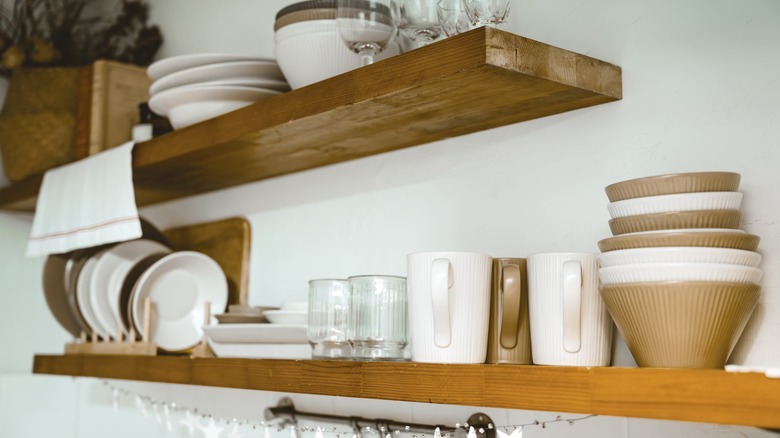 kitchenware on wooden floating shelves