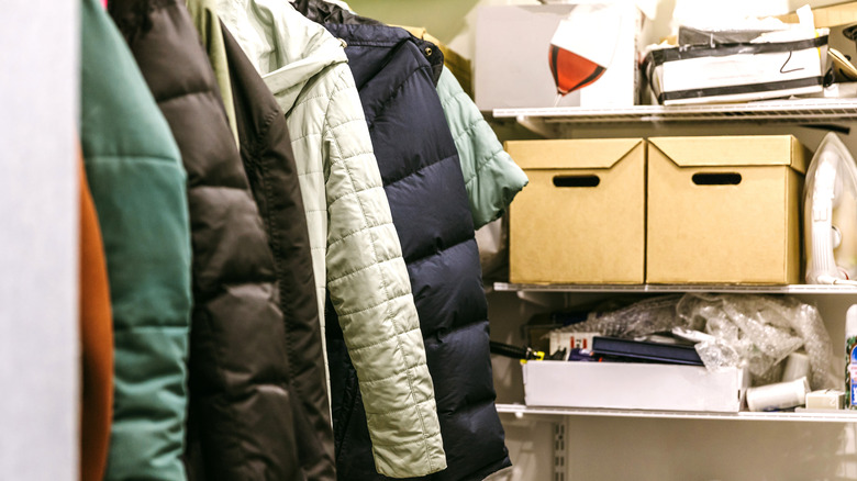 full closet with jackets and boxes