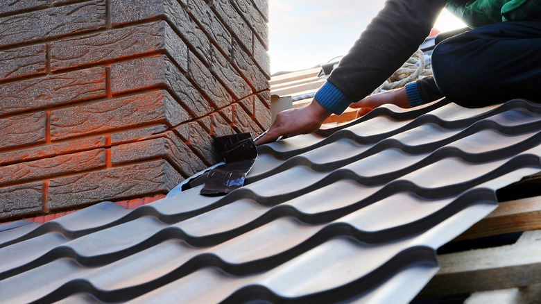 worker on metal shingles