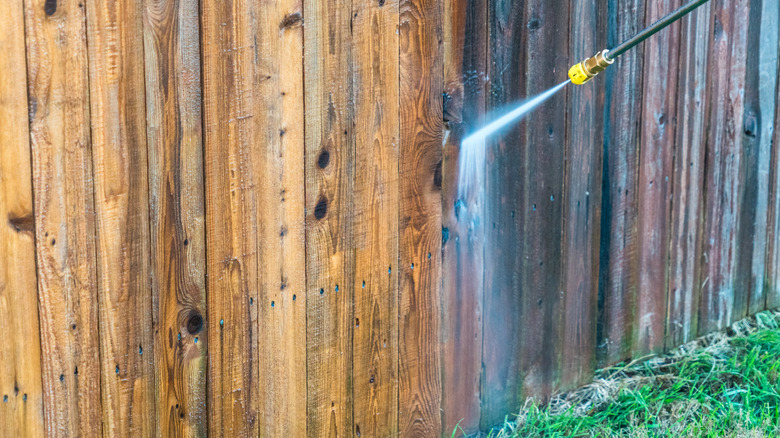 powerwashing a wooden fence