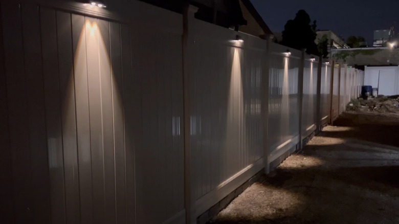 solar lights on a fence at night