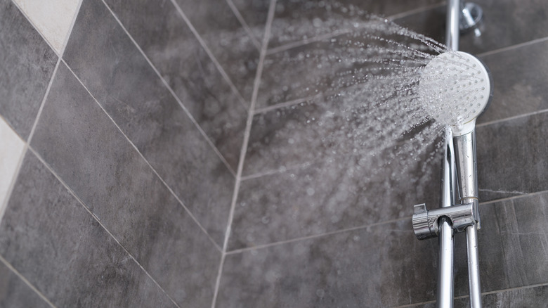 Shower head spraying water into shower