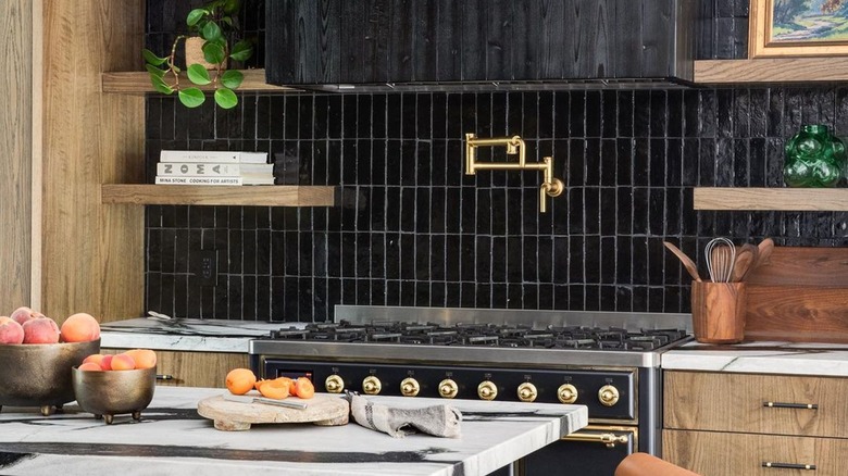 Black zellige tile kitchen backsplash behind stovetop