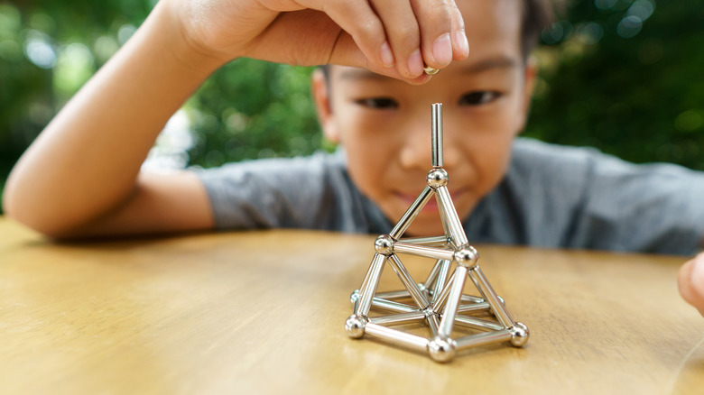 child playing with magnets