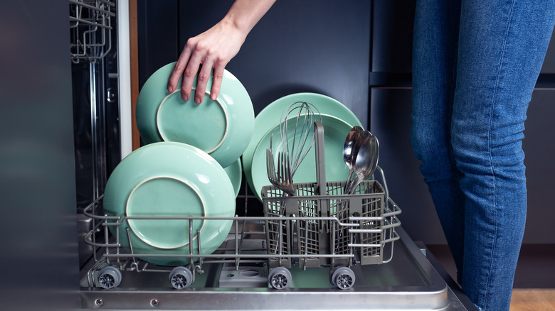 woman loading dishwasher