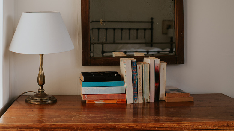 Old books on a bedroom credenza.