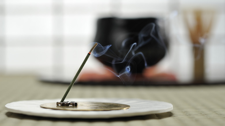 Incense stick on holder in room