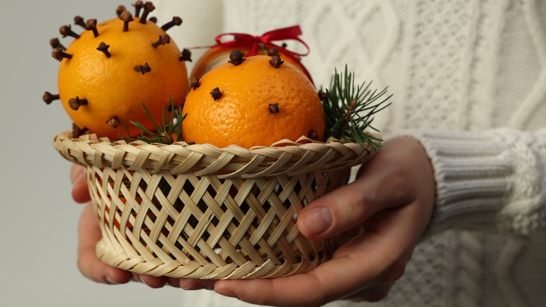 woman holding pomander balls in a wicker basket