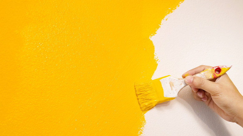 yellow paint and brush