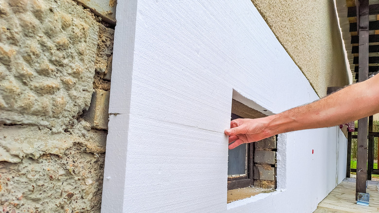 installing rigid polystyrene insulation over wall