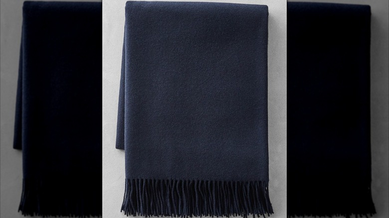 A navy folded Williams Sonoma cashmere blanket