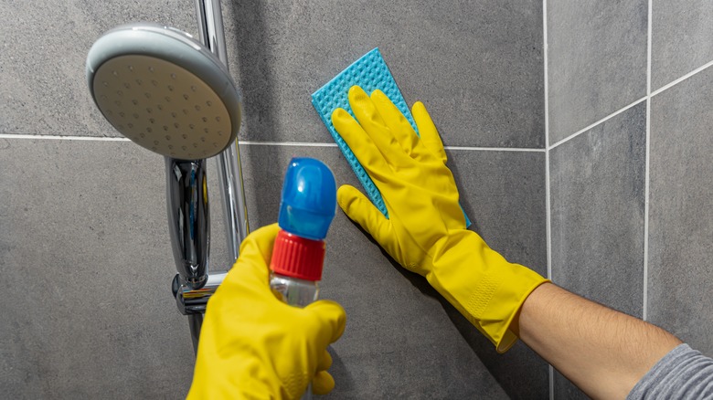 Person removing glue shower wall