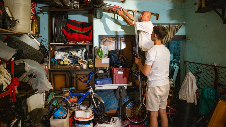 People in cluttered storage area 