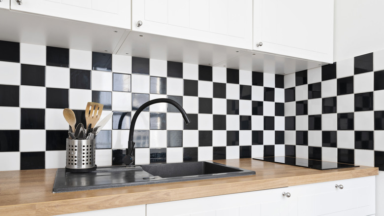 A black and white backsplash in a kitchen