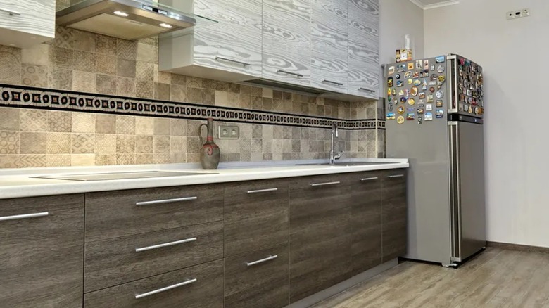 A kitchen with a mosaic tile backsplash