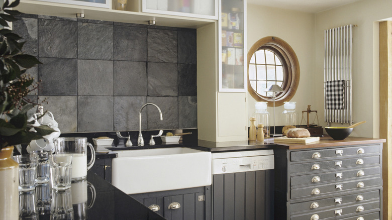 A kitchen with a backsplash made using large tiles