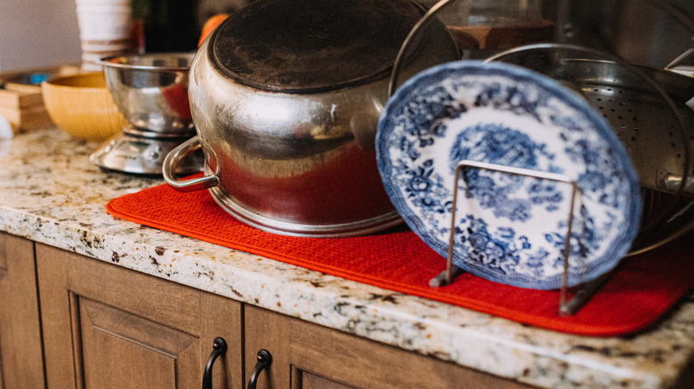 Dishes and pots on top of a drying mat