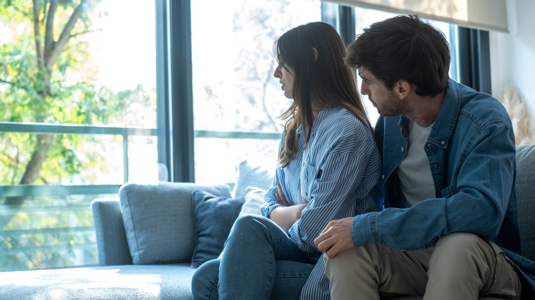 Couple on sofa looking out window