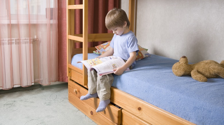 kid on bed with storage