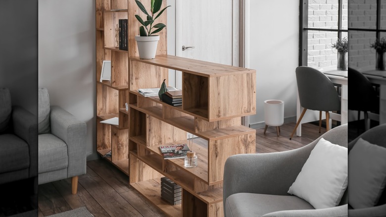 A wooden room dividing shelving unit