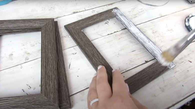 hands painting picture frame