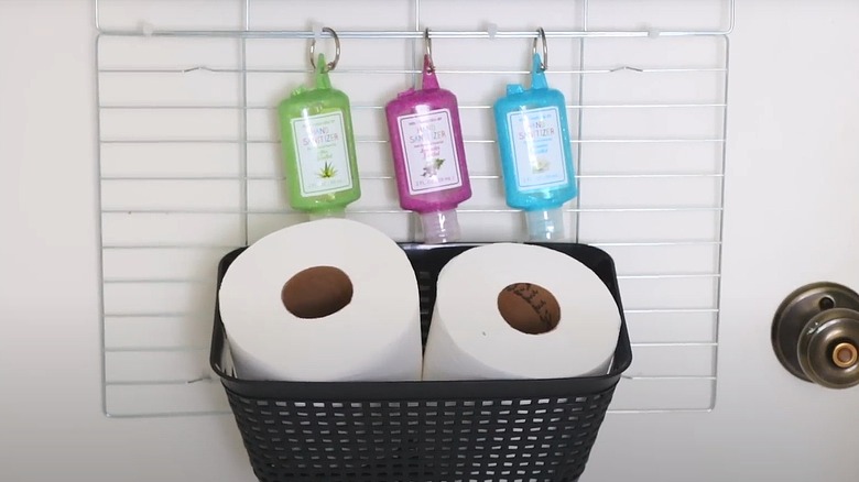 Toilet paper and hand sanitizer hanging on DIY organizer