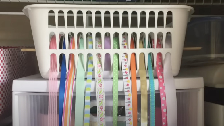 Multi-colored ribbons organized in a white plastic basket