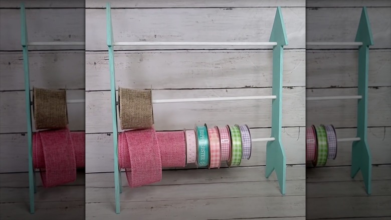 A gift ribbon stand is displayed on a table