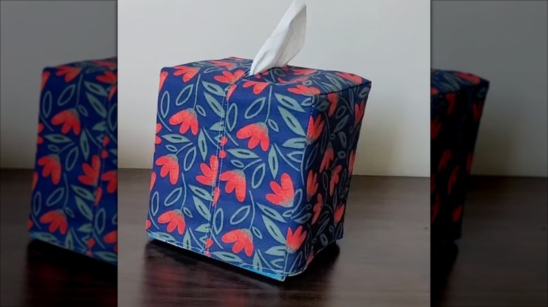 Cloth covered tissue box with tissue pulled out