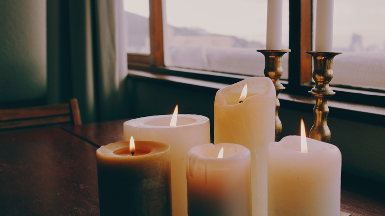 A group of lit candles on a table