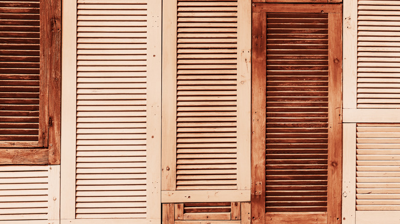 Antique shutters lined against a wall