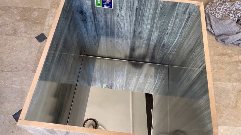 A mirror installed in the bottom of a wooden box