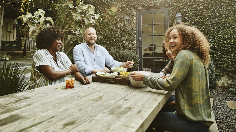 Family sitting at picnic table