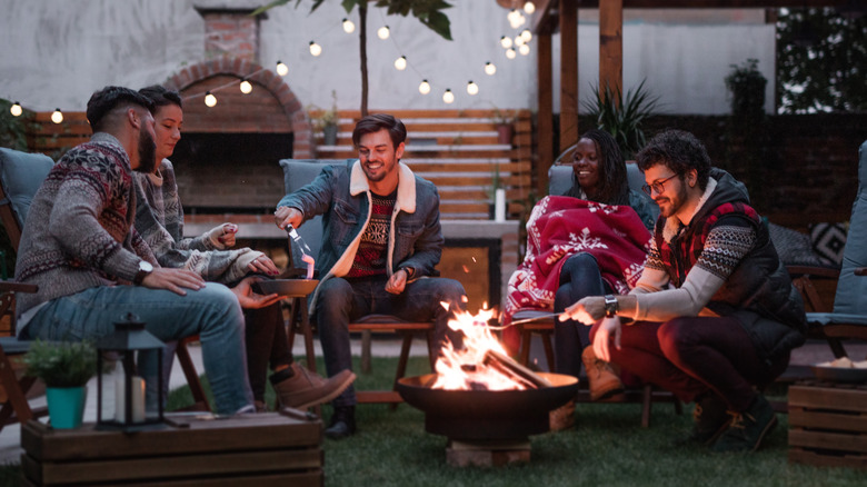 people around backyard firepit