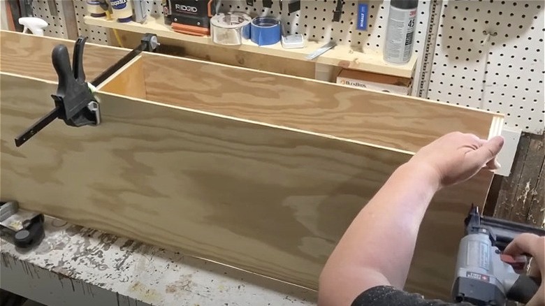 person using finish nailer