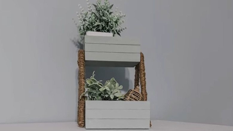 Final product of two tiered planter made from Dollar Tree crates, clothes hanger, and twine