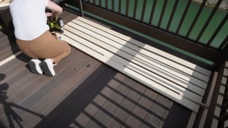 Woman building wood privacy screen