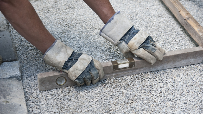 Person leveling gravel