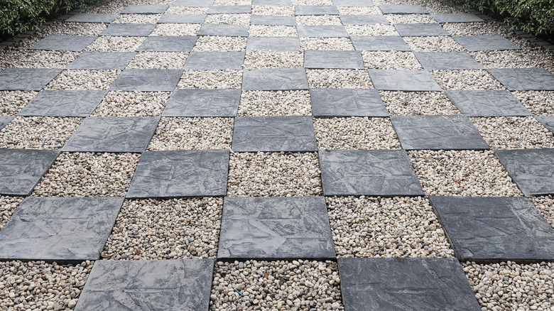 A gravel and paver checkerboard