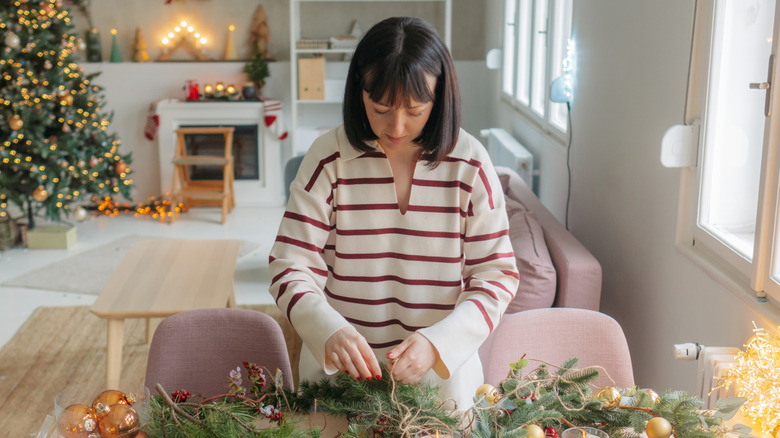 Woman making Christmas decorations in home