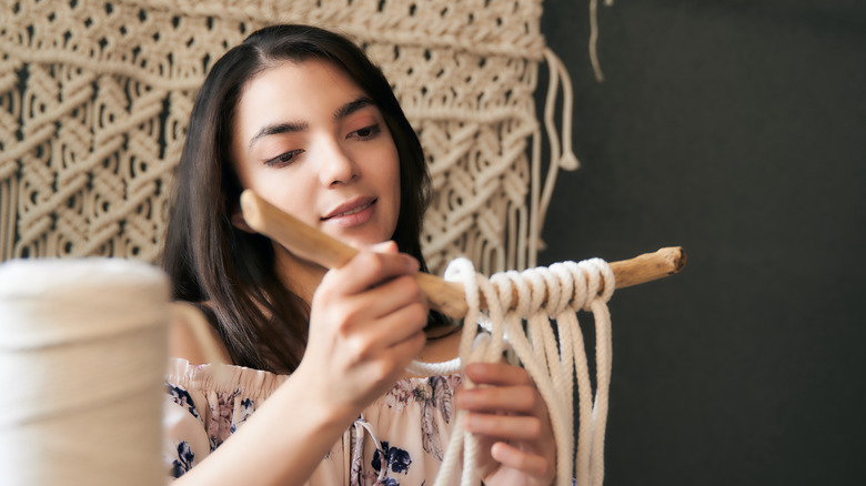 Woman making a macrame craft